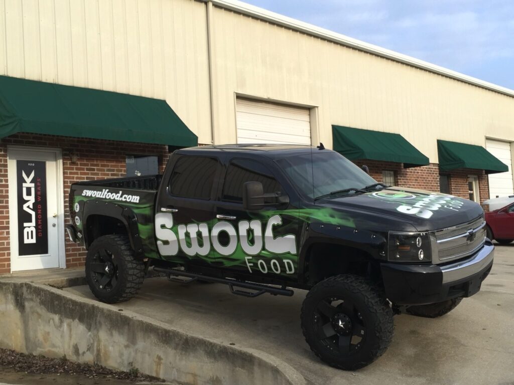 Custom Swoul Food truck wrap hood and side graphics on lifted black Chevrolet Silverado