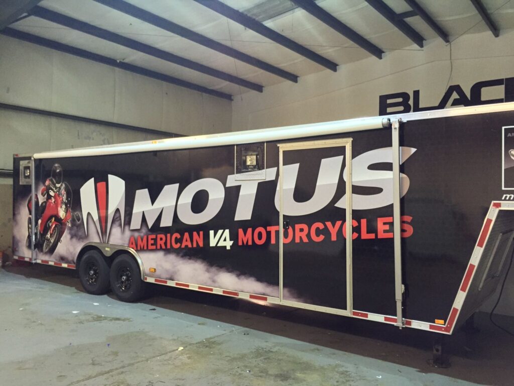 Motus gooseneck cargo trailer wrap inside the Black Diamond Designs shop