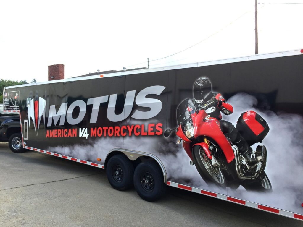 Close view of the Motus trailer wrap rider and red sport-touring motorcycle graphic