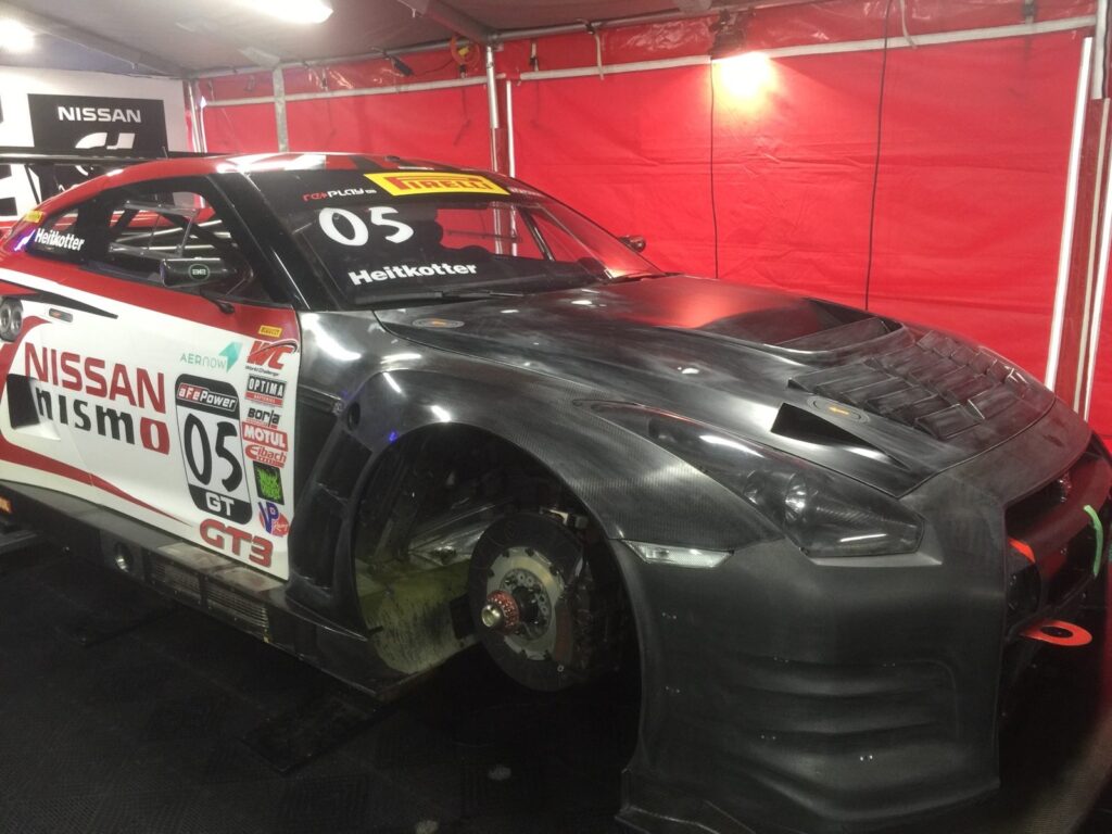 Exposed carbon-fiber front bodywork on the Nissan NISMO GT-R GT3 race car during wrap repair