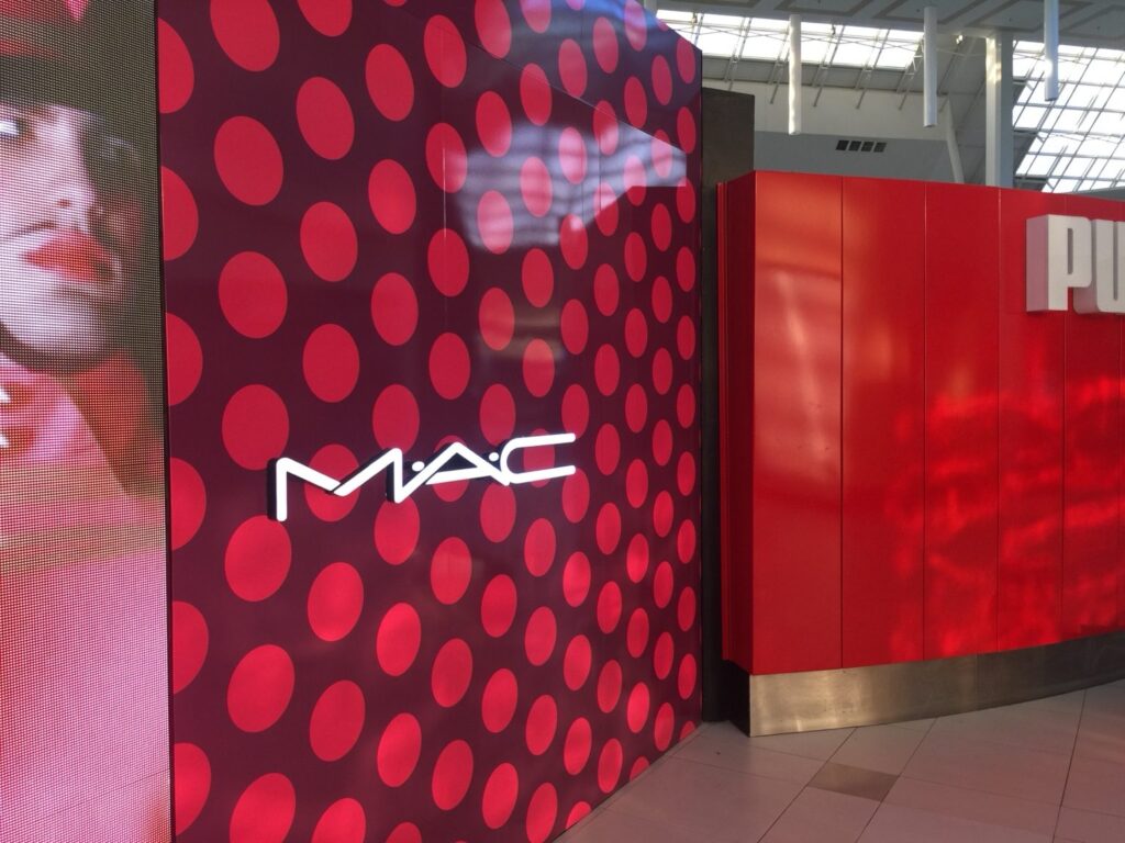 MAC Cosmetics storefront wall graphics beside red retail facade at The Florida Mall