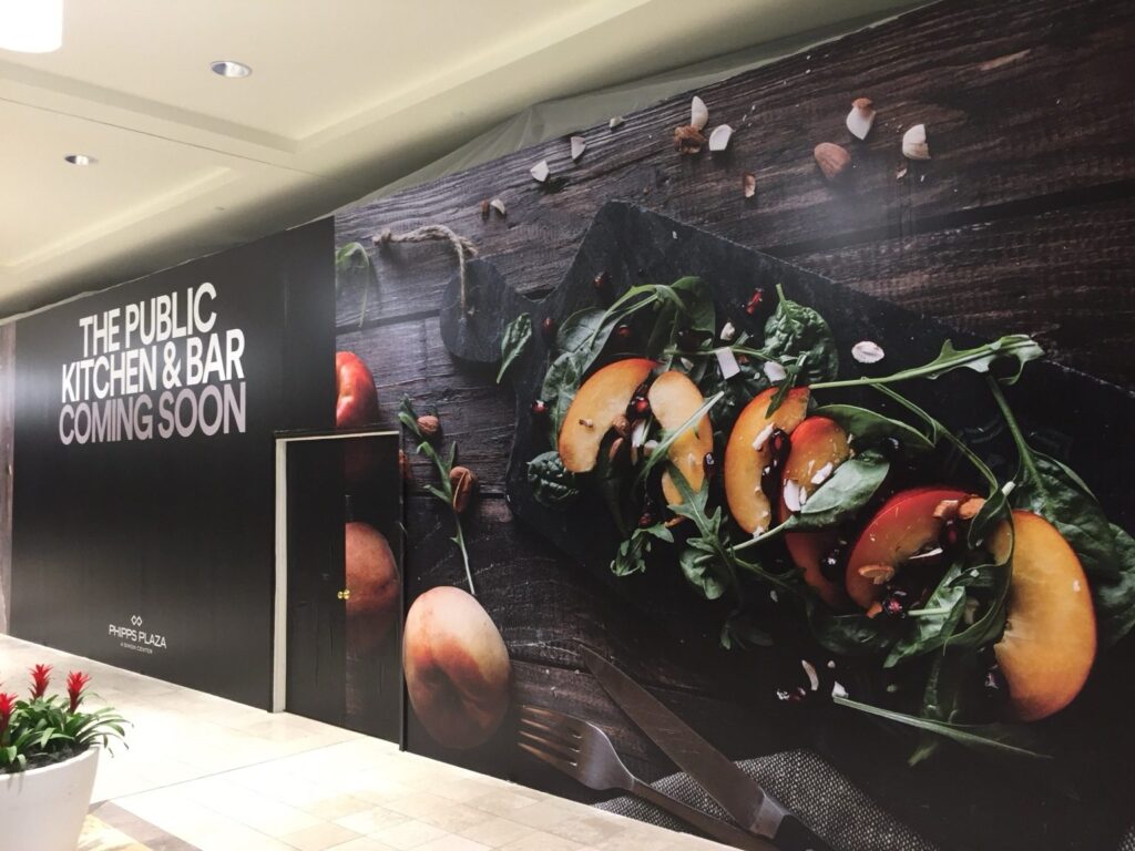 Oversized food photography installed as retail construction barricade graphics for The Public Kitchen & Bar at Phipps Plaza.