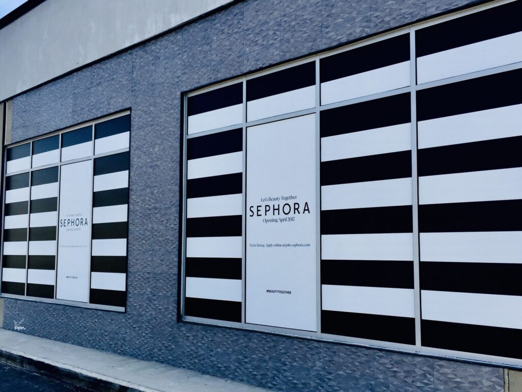 Angled view of Sephora window graphics across two storefront window sections in Buckhead, Atlanta.