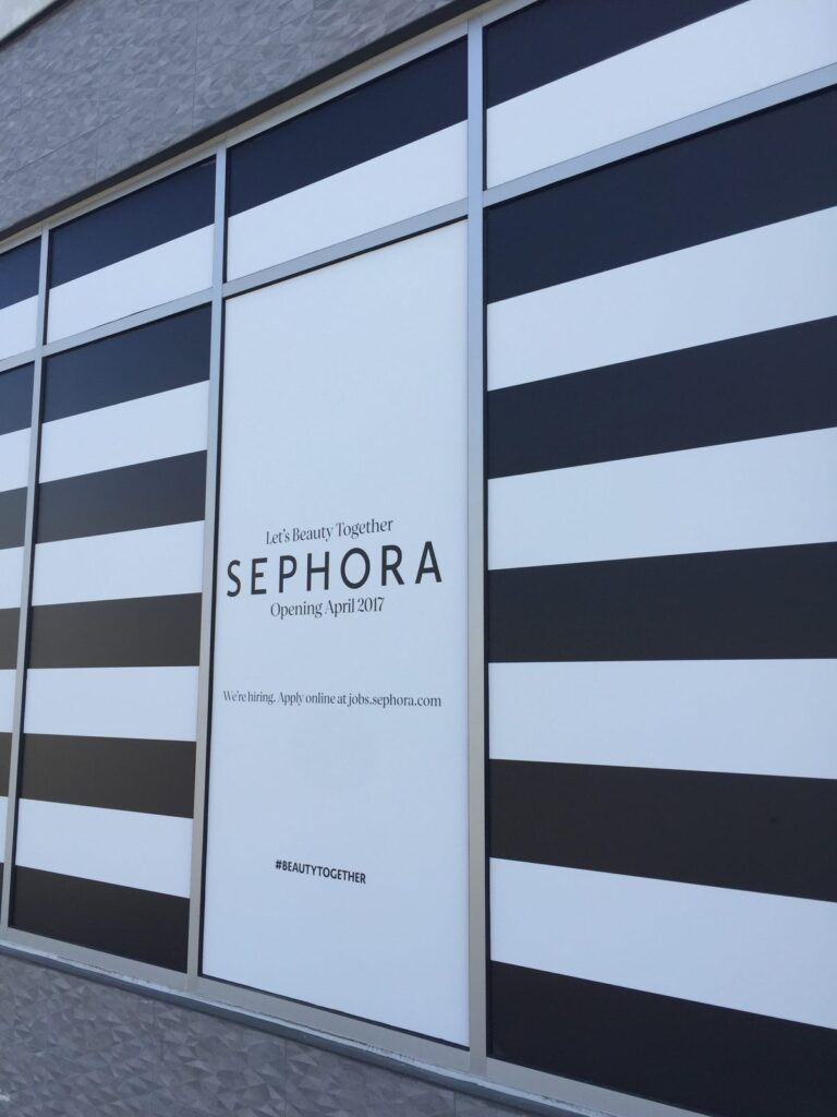 Close-up of Sephora window graphics with black-and-white stripes aligned across adjacent glass panels.