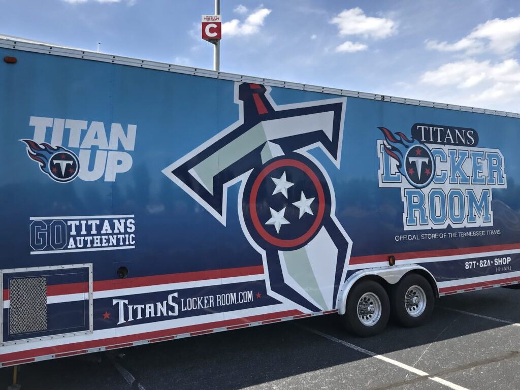 3M graphics installation on Tennessee Titans merchandise cargo trailer featuring Titan Up branding and oversized team logo in Nashville Tennessee.