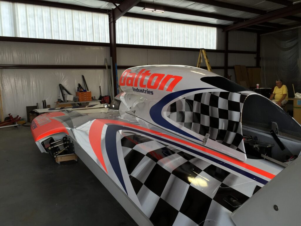 Hydroplane boat wrap installation detail: checkered flag, red and blue stripes and Dalton logo across the U-27 engine cowling.
