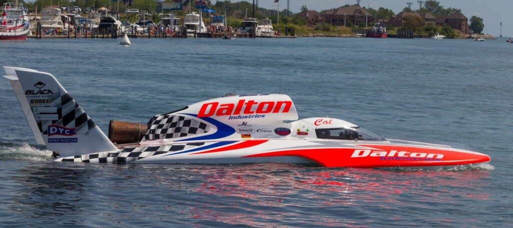 Wrapped U-27 Dalton Industries racing hydroplane on the water, showing its full side graphics and sponsor decals.