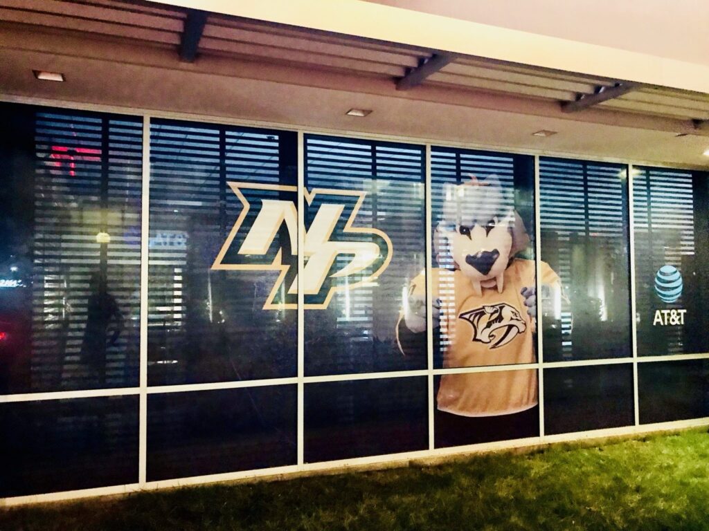 Nashville window graphics with gold NP logo, Gnash mascot, and AT&T globe on perforated window film.