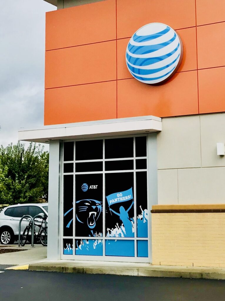 Vertical view of an AT&T building with Panthers window perf below the exterior sign