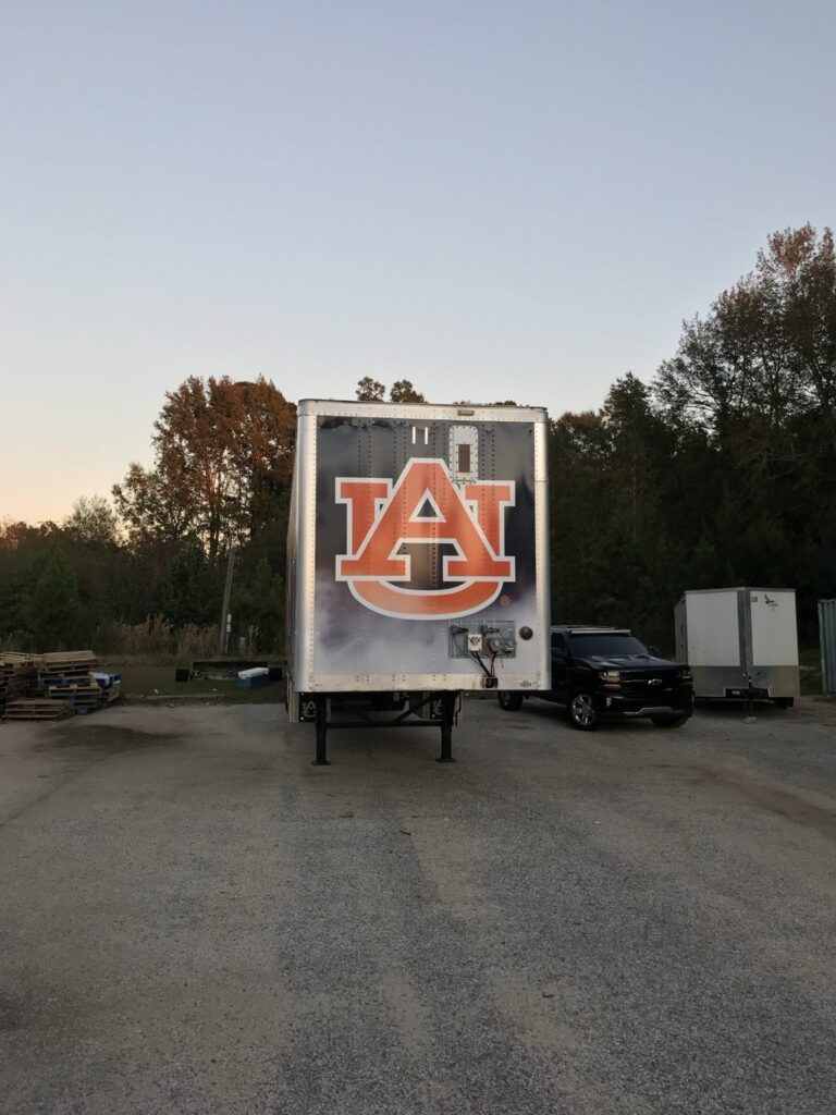 Rear doors of Auburn University football trailer wrap showing large AU logo graphics outdoors