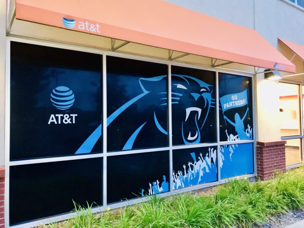 Carolina Panthers window graphics spanning multiple glass panels at an AT&T retail storefront