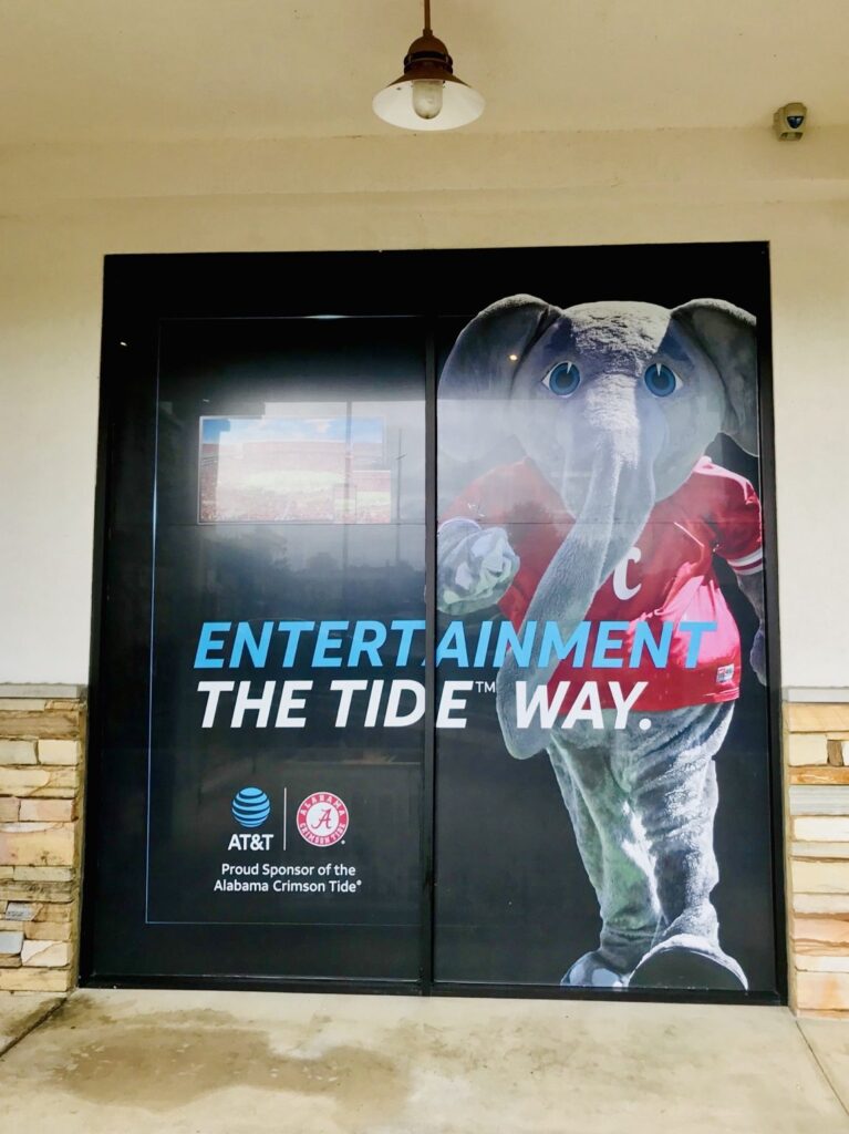 Vertical close view of Alabama Crimson Tide elephant mascot and AT&T logo printed onto large storefront window graphics in the Birmingham area.