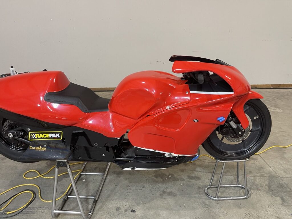 Side profile detail of the red racing motorcycle during the graphics project