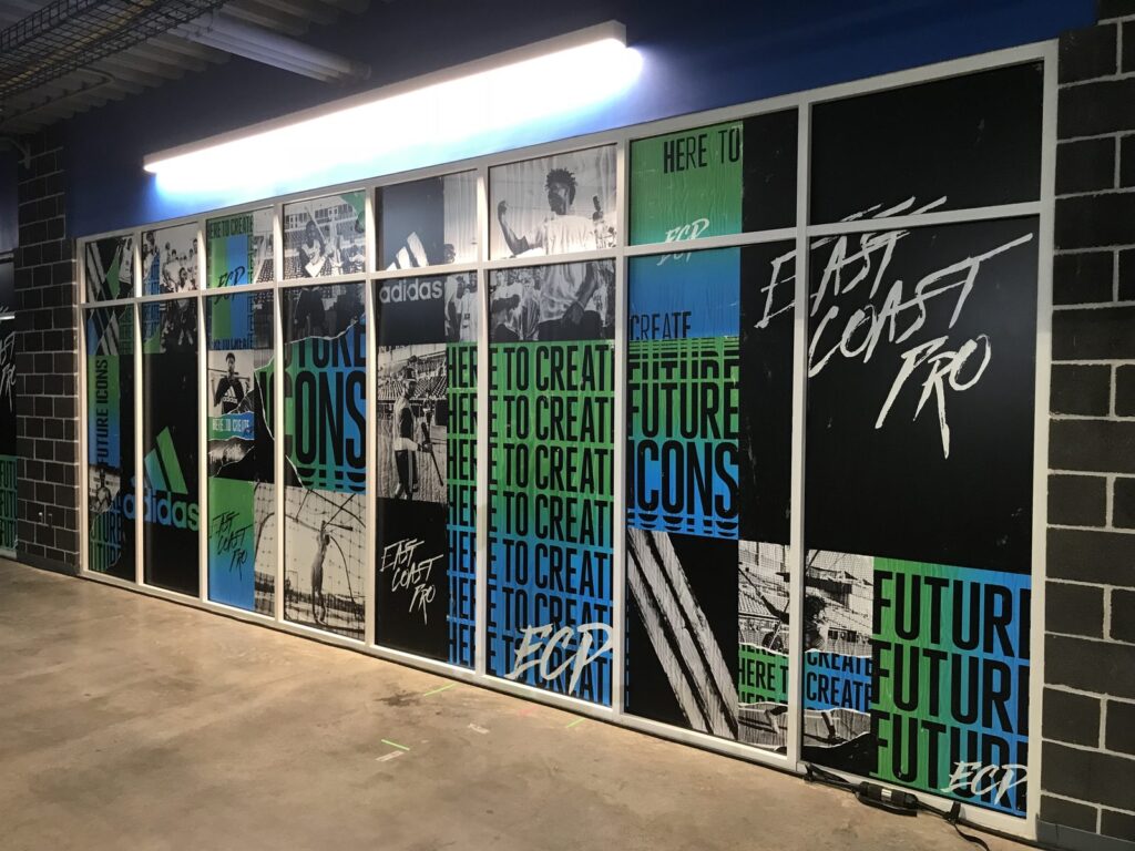 Adidas East Coast Pro vinyl window graphics spanning a wall of framed interior glass panels in Hoover, Alabama.