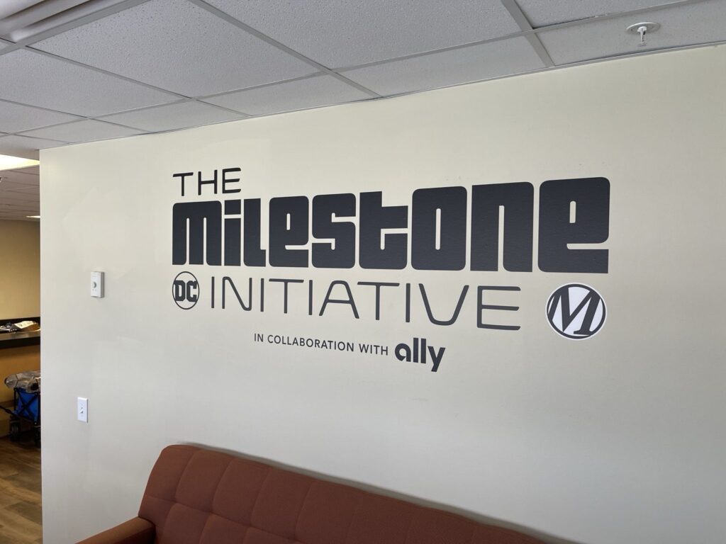 DC Milestone Initiative in collaboration with Ally wall graphic displayed inside an Atlanta Motor Speedway NASCAR hospitality area