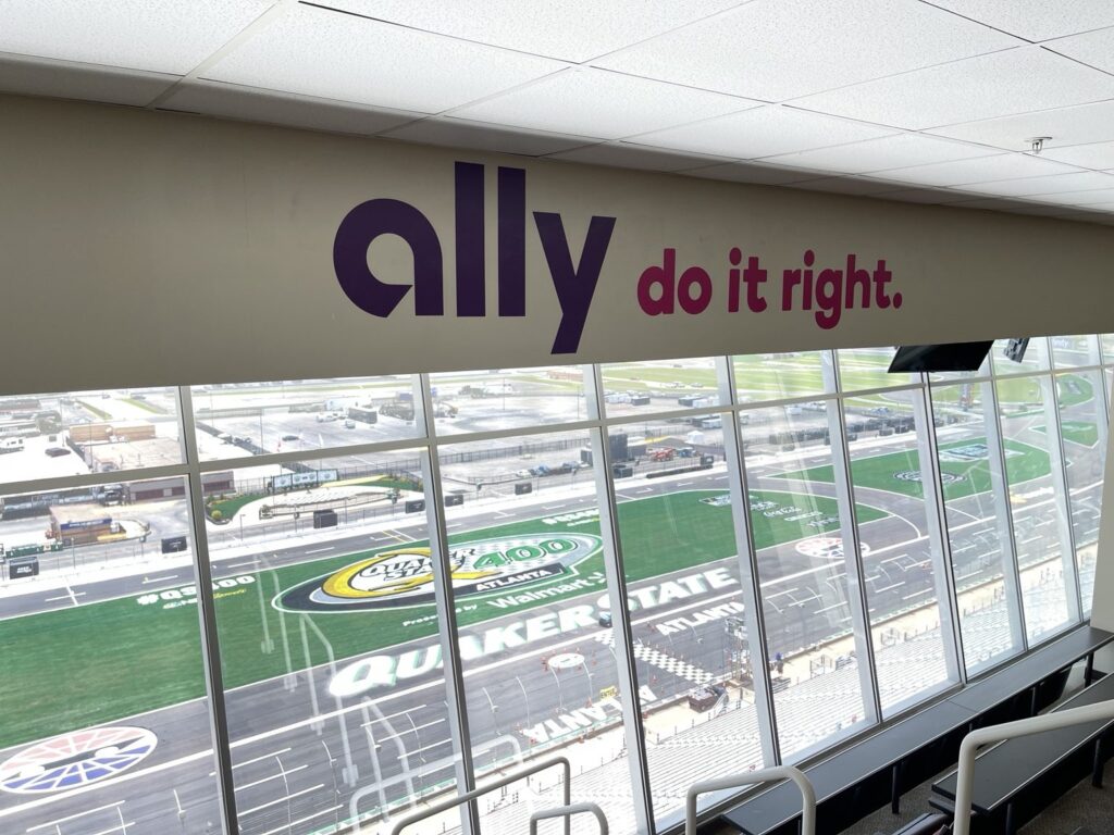 Ally do it right slogan installed above large press-box windows overlooking the Quaker State 400 infield at Atlanta Motor Speedway