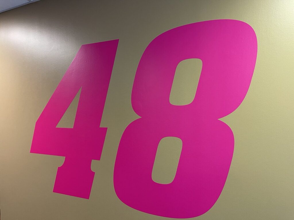 Large magenta number 48 installed on an interior hospitality suite wall at Atlanta Motor Speedway
