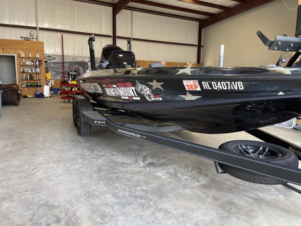 Angled bow view of the Skeeter with distressed flag graphics and fishing logos