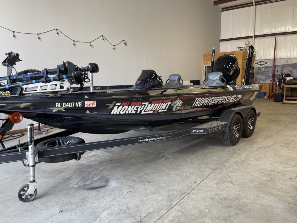 Skeeter bass boat wrap: full side view with patriotic graphics and fishing-brand artwork on a trailer