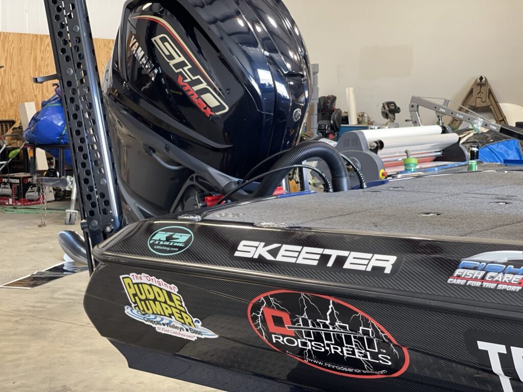 Skeeter with outboard motor and fishing-brand graphics on the rear hull