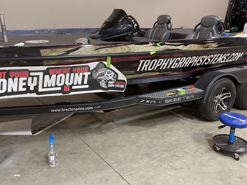 Printed wrap panel with alignment tape positioned along the Skeeter hull