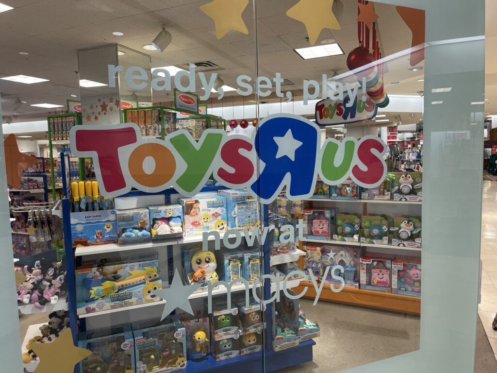 Toys R Us storefront window graphics at Macy's in Riverchase Galleria, Hoover, featuring colorful Toys R Us branding and ready, set, play lettering on glass.