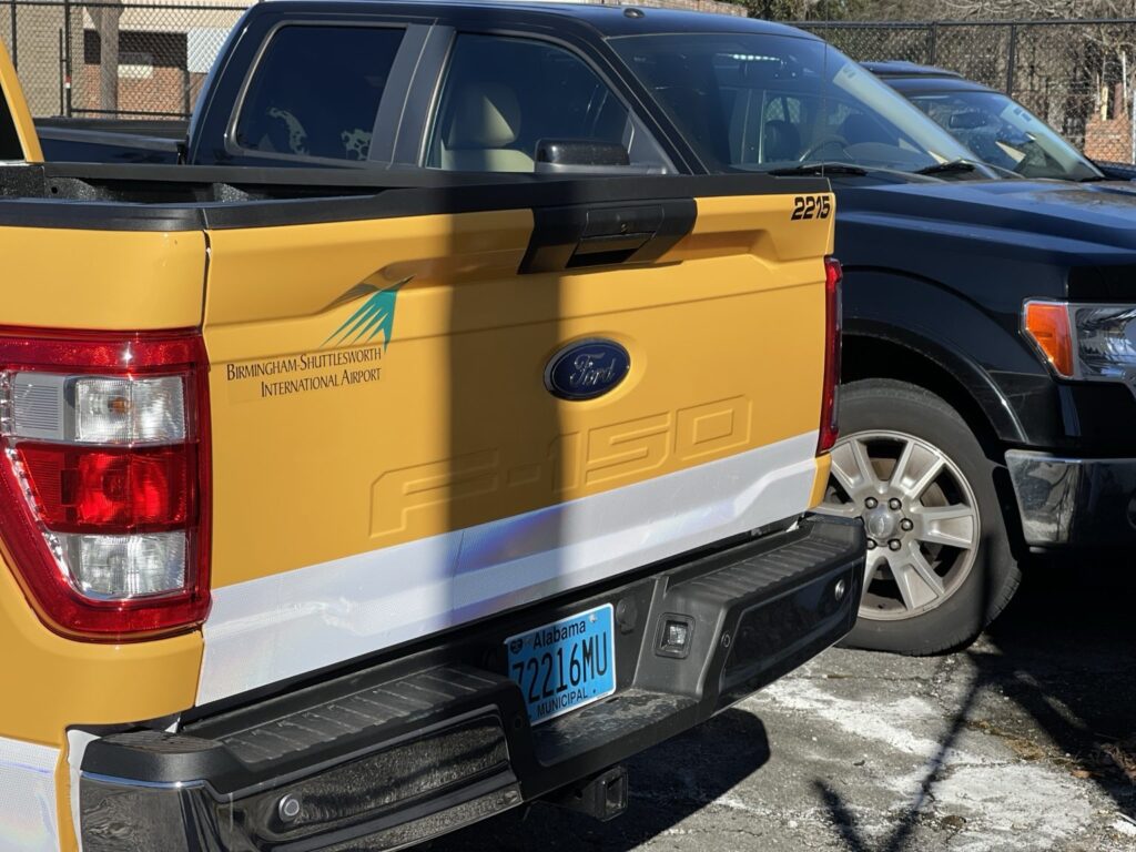 Tailgate of airport service truck 2215 with matching graphics