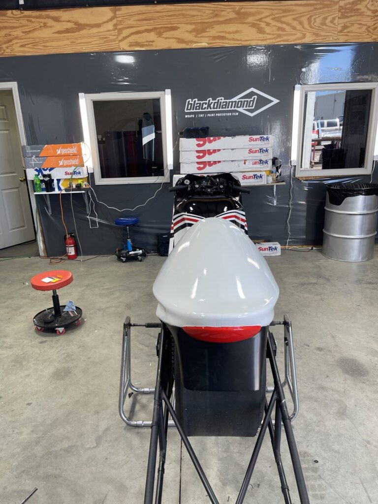 Rear view of the race motorcycle showing custom bodywork and graphics