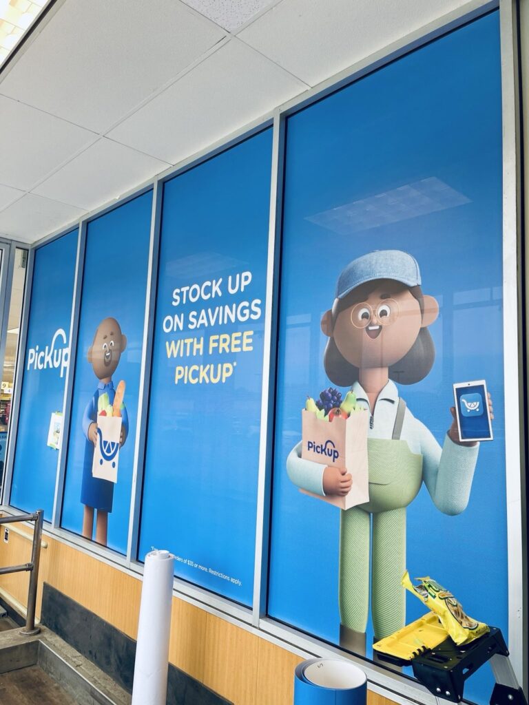 Kroger PickUp perforated window graphics across blue storefront glass in Auburn Hills, Michigan