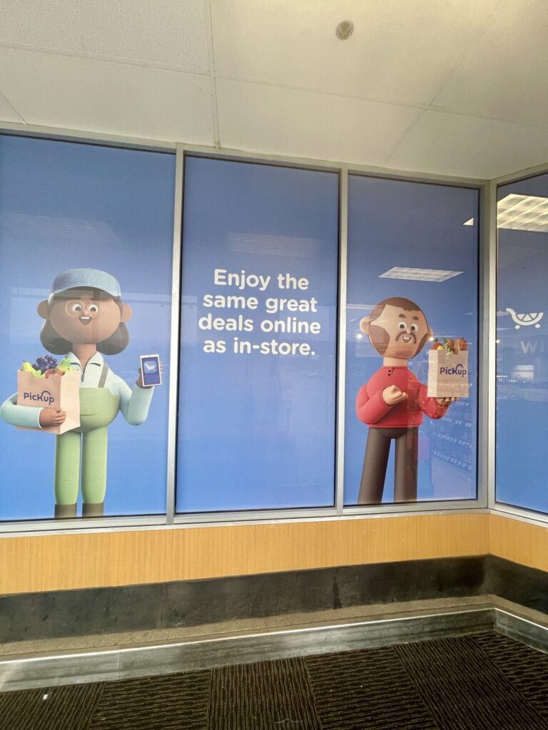 Kroger PickUp window graphics wrapping interior corner glass with two illustrated shoppers
