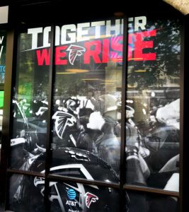 Window graphics printed and installed for AT&T and the Atlanta Falcons by Black Diamond Designs featuring bold retail storefront branding
