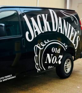 Full coverage branded van graphics installed for Jack Daniel’s fleet by certified 3M installer Black Diamond Designs