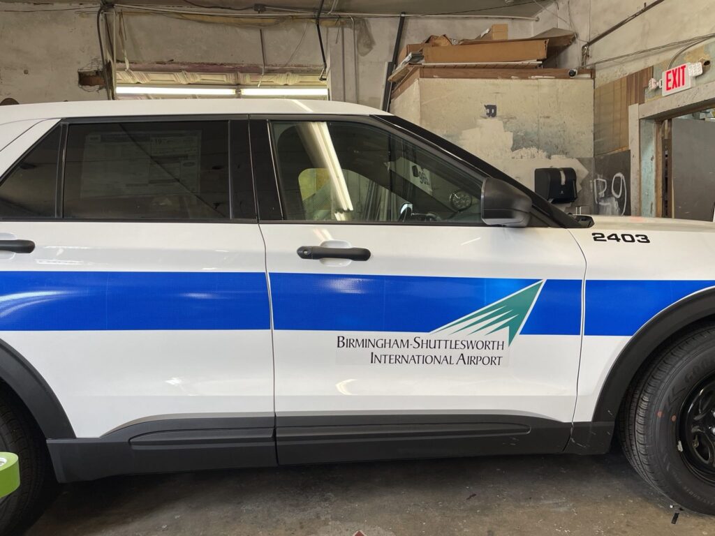 Side profile of patrol vehicle 2403 with reflective striping and branding