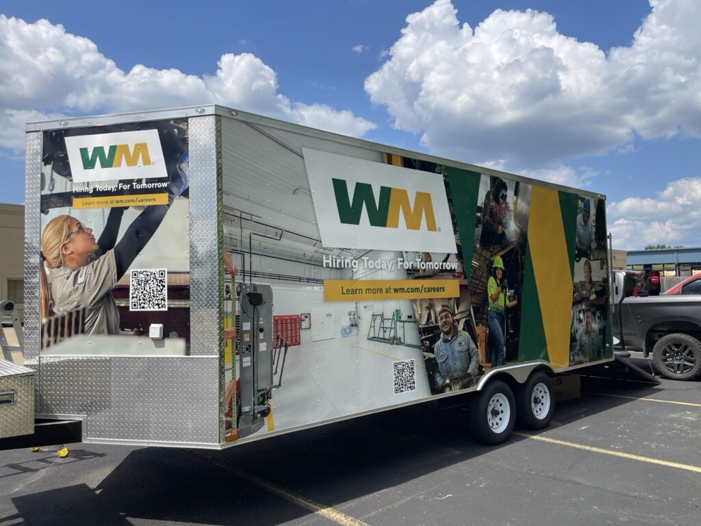 Waste Management trailer wrap with WM logo, employee images and a QR code in Troy, Michigan