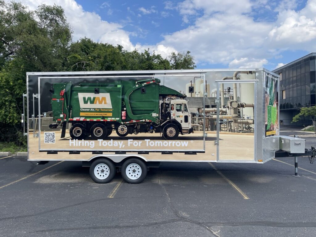 Side view of the WM trailer wrap with a sanitation vehicle and Hiring Today, For Tomorrow message