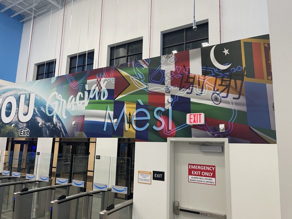 Multilingual wall graphics with flags near exit signage