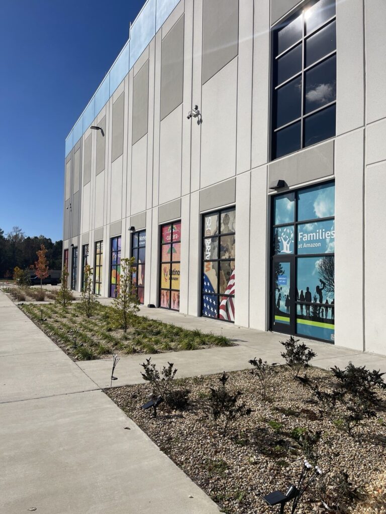 Side facade of the Amazon facility with exterior window graphics