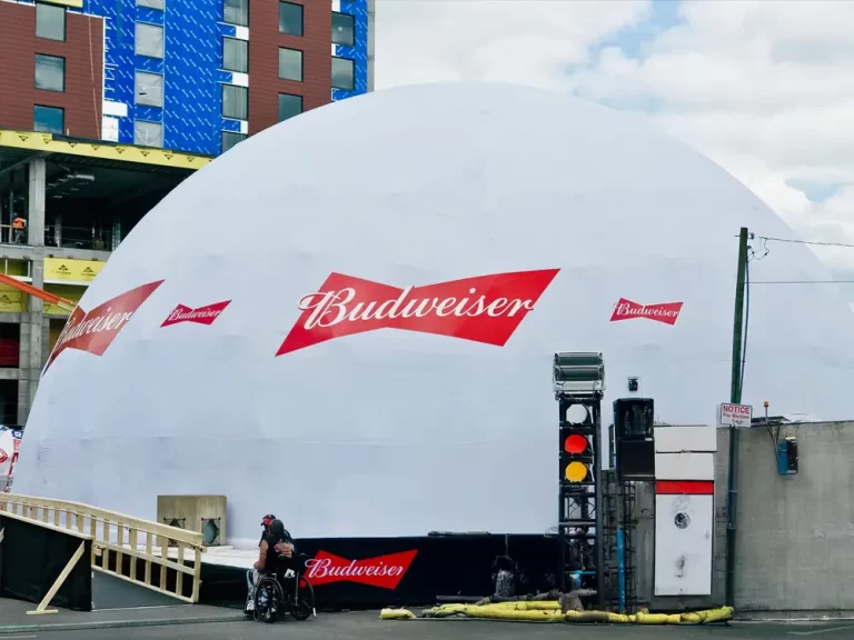 Budweiser-branded white dome with red logos outside a commercial building