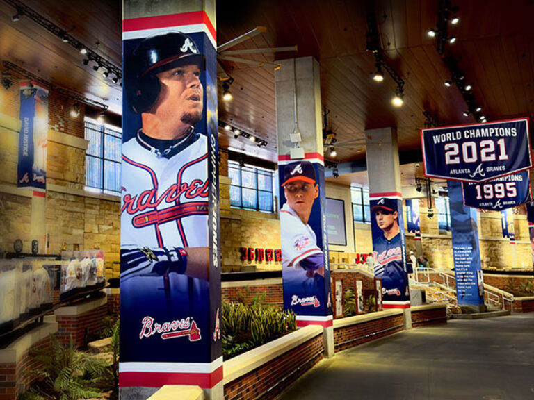 Atlanta Braves player graphics wrapped around stadium concourse columns