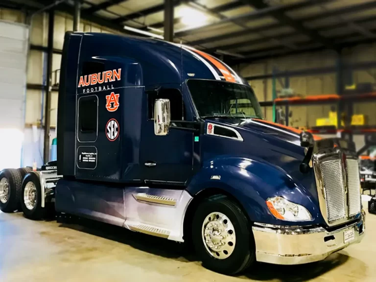 Auburn football graphics on a navy semi-truck cab