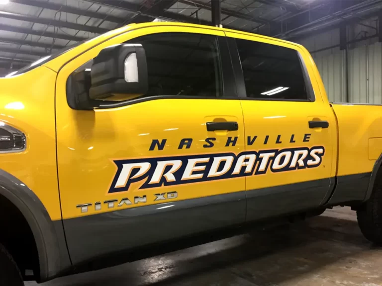 Nashville Predators branding on a yellow pickup truck