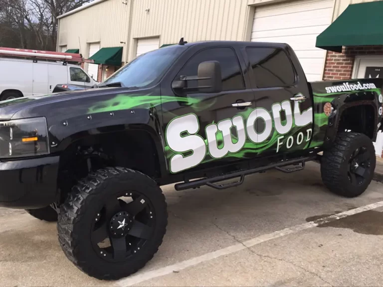Swoul Food green-and-black graphics on a lifted pickup truck