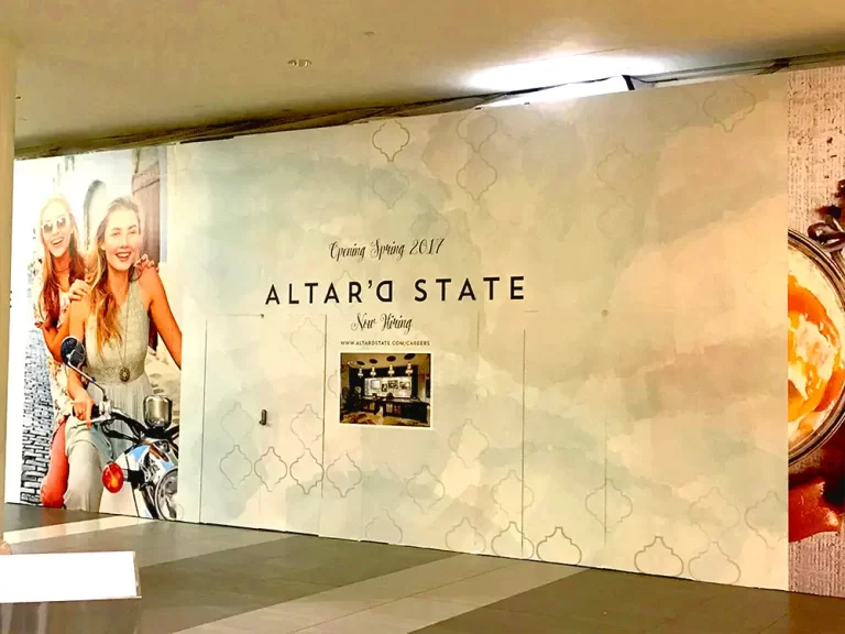 Altar’d State Coming Soon graphics on a retail construction barricade