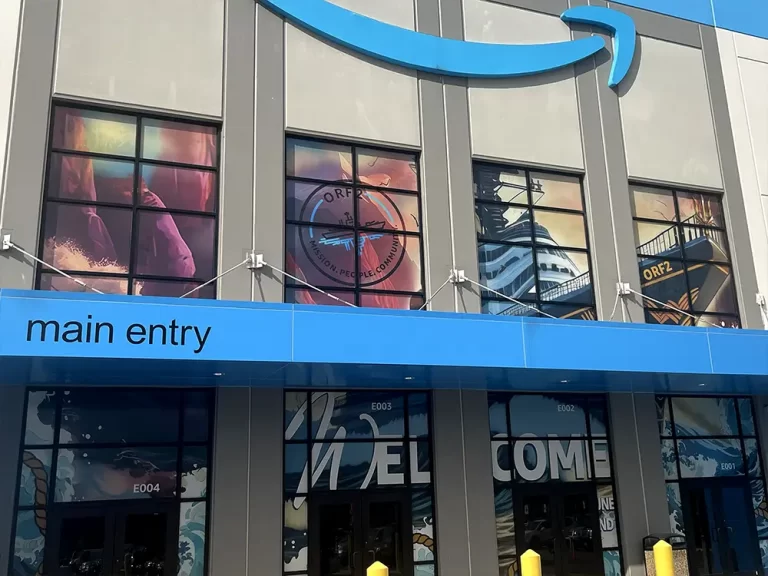 Large printed window graphics above a blue commercial entrance