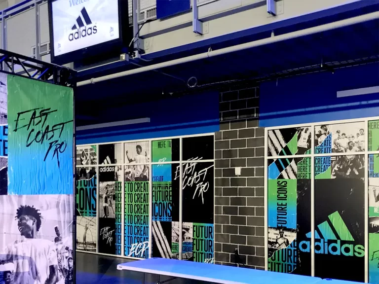 Adidas promotional collage graphics across retail windows