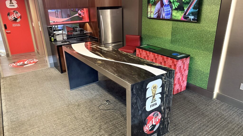 Coca-Cola FIFA World Cup executive suite sports graphics installation in Atlanta, Georgia, featuring custom branded furniture and interior graphics.