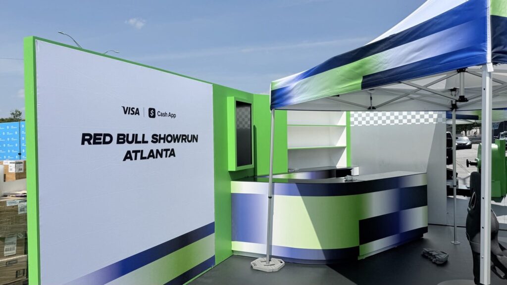 Red Bull Showrun graphics installed at a Visa and Cash App activation with a branded curved counter in Summerhill, Atlanta