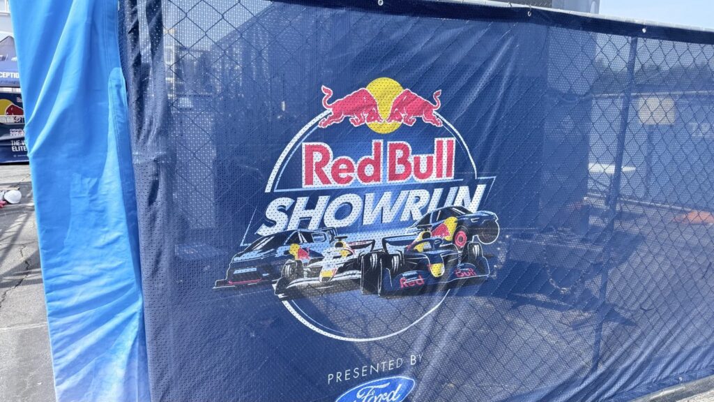 Red Bull Showrun mesh fence banner with race cars and Ford branding in Atlanta