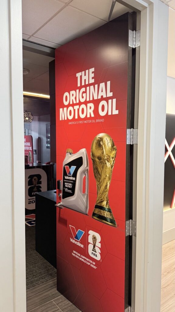 Hinge-side view of the Valvoline FIFA World Cup 2026 door graphic in a stadium suite