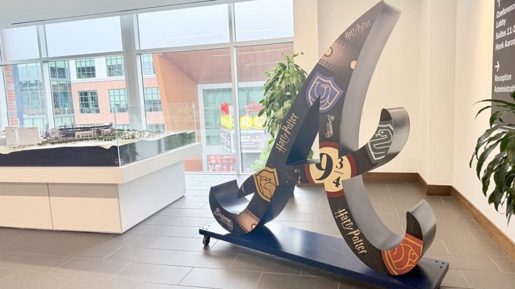 Harry Potter Night themed Braves logo sculpture beside a stadium lobby display case